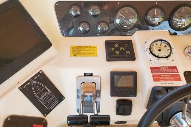 Basic Instinct Yacht Photos Pics Control panel of a 1995 Sea Ray 440 Express Bridge boat with gauges and switches.