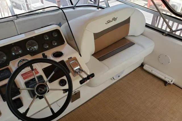 Basic Instinct Yacht Photos Pics 1995 Sea Ray 440 Express Bridge helm with steering wheel and control panel.
