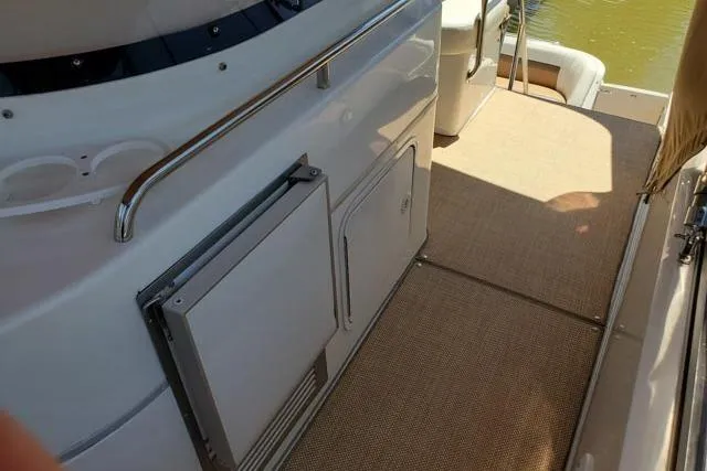 Basic Instinct Yacht Photos Pics 1995 Sea Ray 440 Express Bridge deck with storage compartments and railing.