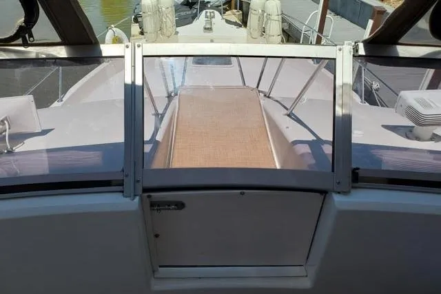 Basic Instinct Yacht Photos Pics 1995 Sea Ray 440 Express Bridge boat deck view with clear glass door.