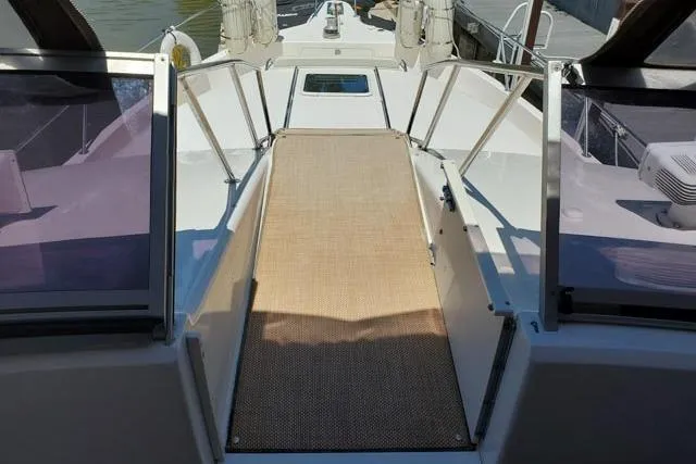 Basic Instinct Yacht Photos Pics 1995 Sea Ray 440 Express Bridge deck with walkway and railing.