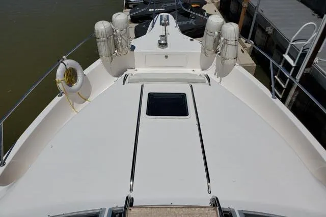 Basic Instinct Yacht Photos Pics 1995 Sea Ray 440 Express Bridge yacht deck with lifebuoys and fenders at dock.