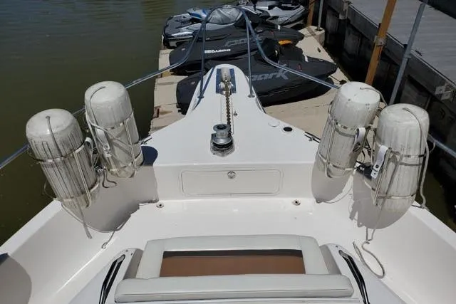 Basic Instinct Yacht Photos Pics 1995 Sea Ray 440 Express Bridge yacht bow with fenders and docked jet skis.