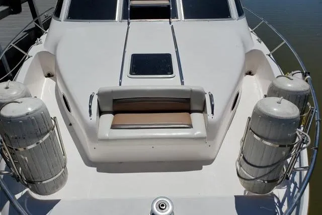 Basic Instinct Yacht Photos Pics 1995 Sea Ray 440 Express Bridge yacht deck with seating and fenders.