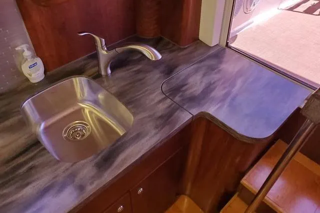 Basic Instinct Yacht Photos Pics 1995 Sea Ray 440 Express Bridge kitchen sink with modern faucet and countertop.