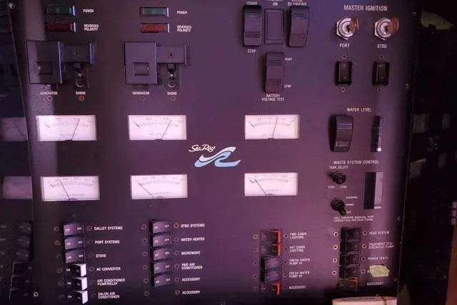 Basic Instinct Yacht Photos Pics Control panel of a 1995 Sea Ray 440 Express Bridge boat with various switches and gauges.