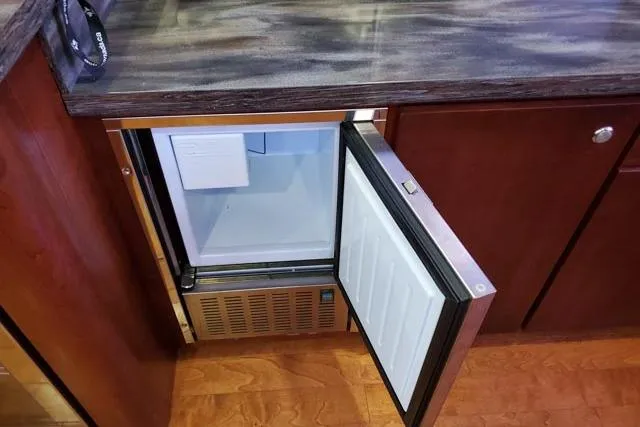 Basic Instinct Yacht Photos Pics Open mini fridge in 1995 Sea Ray 440 Express Bridge yacht kitchen.