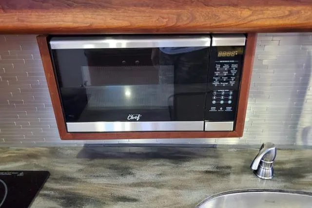 Basic Instinct Yacht Photos Pics Built-in microwave in 1995 Sea Ray 440 Express Bridge kitchen area.