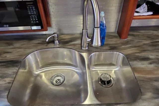 Basic Instinct Yacht Photos Pics Stainless steel double sink with modern faucet on Sea Ray 440 Express Bridge yacht.