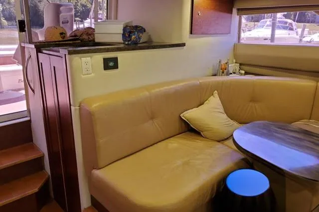 Basic Instinct Yacht Photos Pics 1995 Sea Ray 440 Express Bridge interior with beige seating and wooden accents.