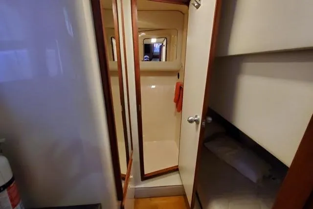 Basic Instinct Yacht Photos Pics Interior of 1995 Sea Ray 440 Express Bridge showing bathroom and sleeping area.