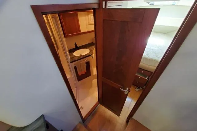 Basic Instinct Yacht Photos Pics Interior view of 1995 Sea Ray 440 Express Bridge, featuring a bathroom and bedroom.