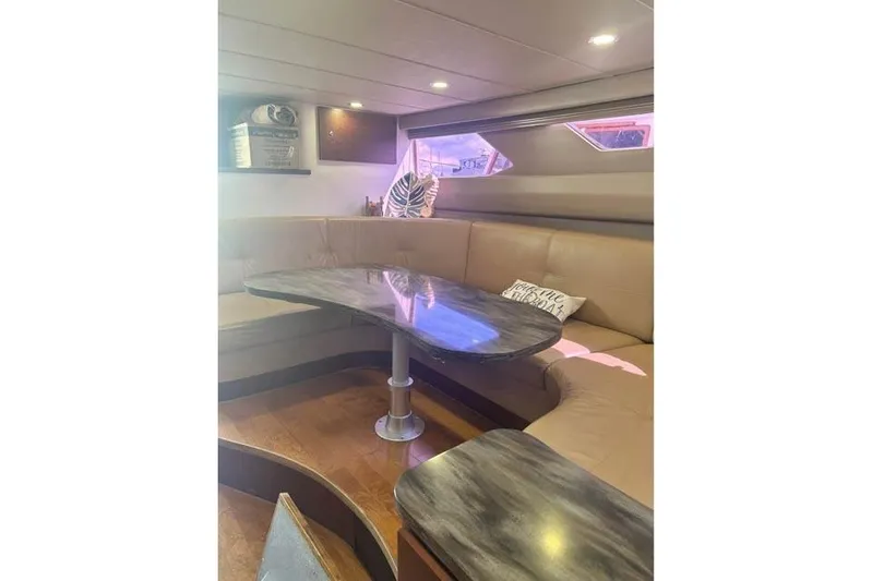 Basic Instinct Yacht Photos Pics Interior of 1995 Sea Ray 440 Express Bridge with cozy seating and table.