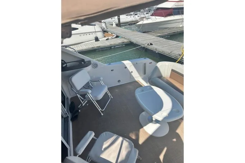 Basic Instinct Yacht Photos Pics 1995 Sea Ray 440 Express Bridge yacht interior with seating and table at dock.