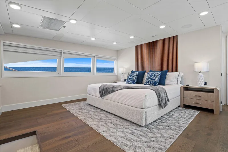 Panacea Yacht Photos Pics Luxurious bedroom on 2011 Mengi Yay 115 MY yacht with ocean view and modern decor.