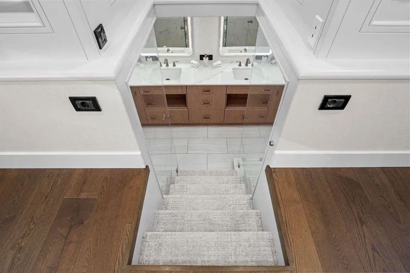 Panacea Yacht Photos Pics Staircase leading to a modern bathroom with dual sinks on a 2011 Mengi Yay 115 MY yacht.