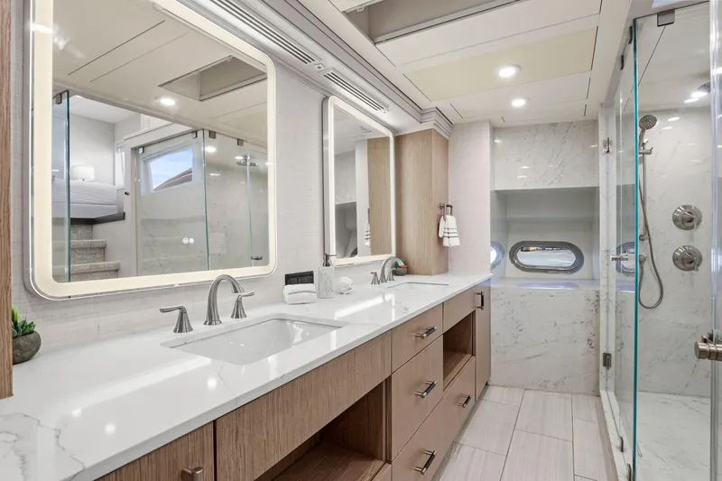 Panacea Yacht Photos Pics Luxurious yacht bathroom with dual sinks, modern fixtures, and glass shower in Mengi Yay 115 MY.