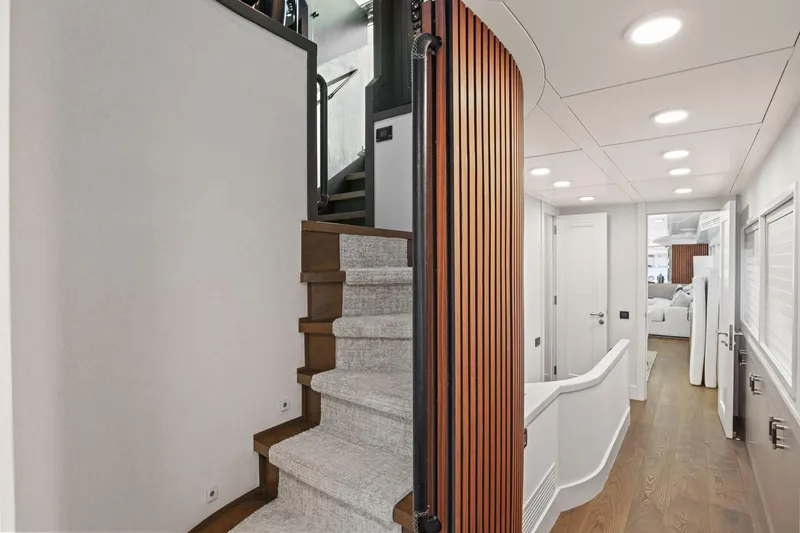 Panacea Yacht Photos Pics Luxurious interior of 2011 Mengi Yay 115 MY yacht with modern staircase and hallway.