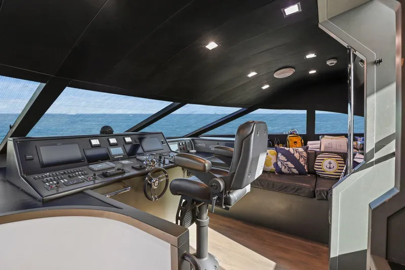 Panacea Yacht Photos Pics Pilothouse interior of 2011 Mengi Yay 115 MY yacht with modern controls and ocean view.