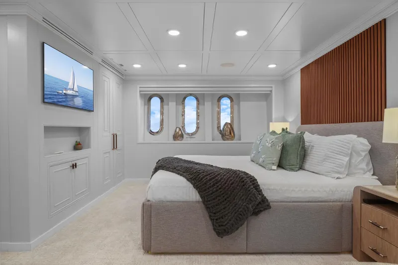 Panacea Yacht Photos Pics Luxurious bedroom on 2011 Mengi Yay 115 MY yacht with elegant decor and ocean view.