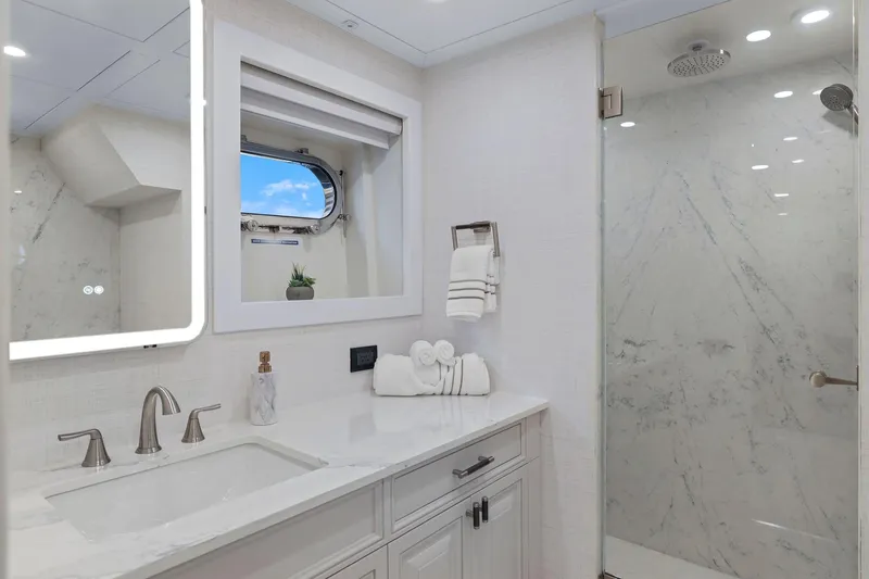Panacea Yacht Photos Pics Luxurious yacht bathroom with marble shower, elegant fixtures, and porthole window on Mengi Yay 115 MY.