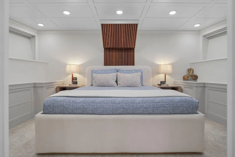 Panacea Yacht Photos Pics Luxurious bedroom interior on 2011 Mengi Yay 115 MY yacht, featuring elegant decor and ambient lighting.