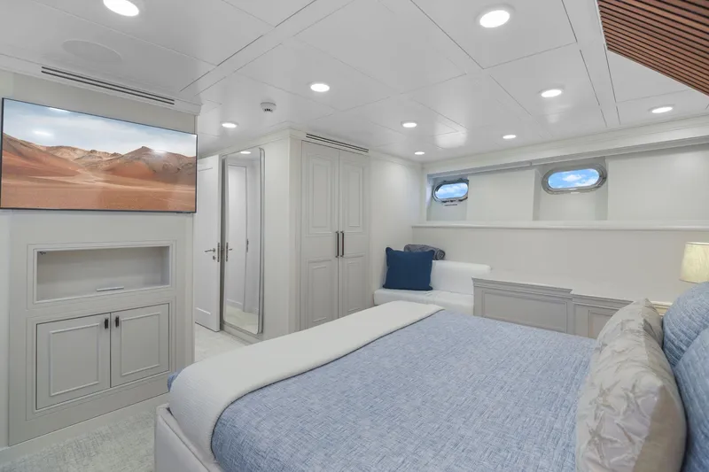 Panacea Yacht Photos Pics Luxurious bedroom interior on 2011 Mengi Yay 115 MY yacht with modern decor and porthole windows.