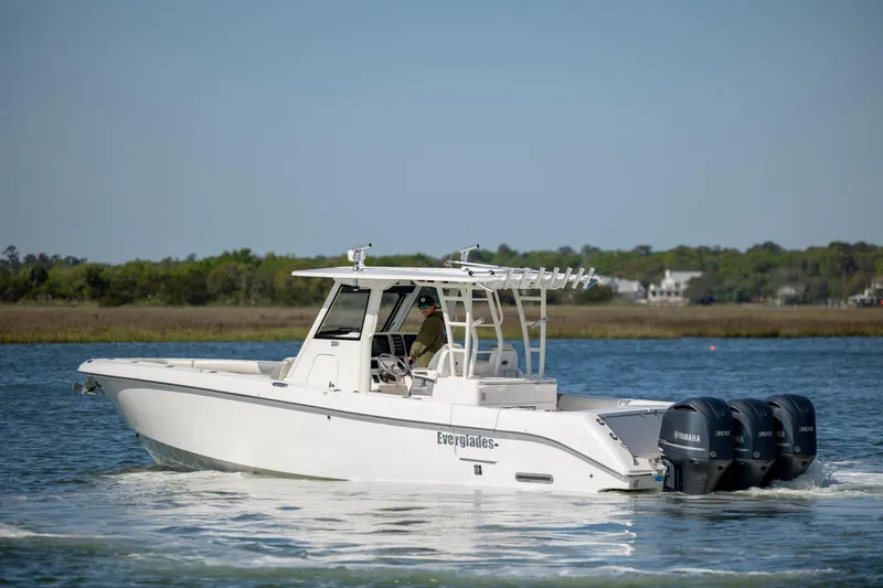  Yacht Photos Pics 2017 Everglades 355 Tournament boat cruising on a calm lake with triple outboard engines.