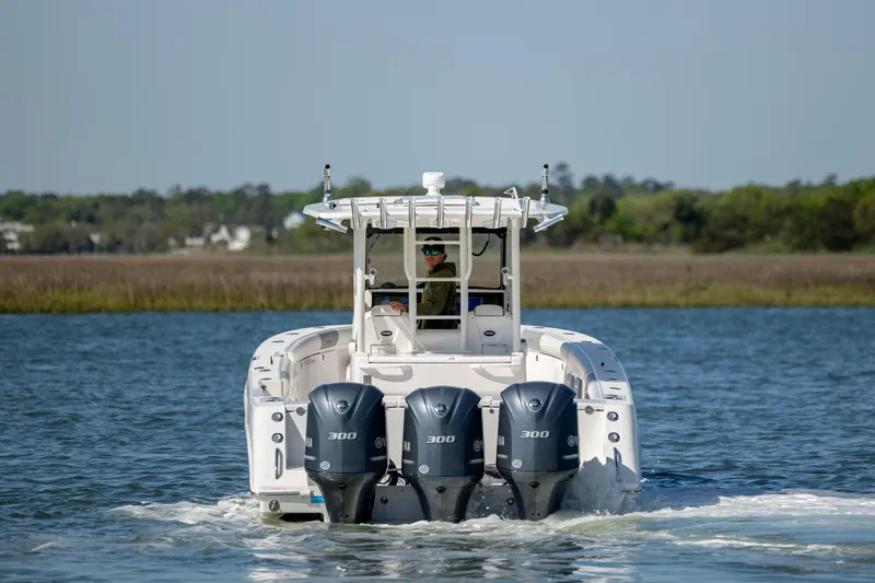  Yacht Photos Pics 2017 Everglades 355 Tournament boat with triple engines cruising on a calm lake.
