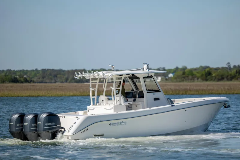  Yacht Photos Pics 2017 Everglades 355 Tournament boat with triple Yamaha engines on a calm waterway.