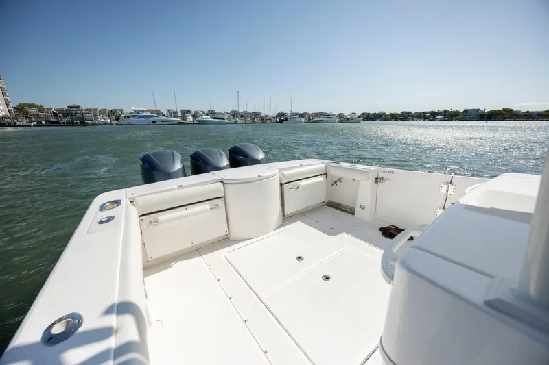  Yacht Photos Pics 2017 Everglades 355 Tournament boat deck with triple outboard motors on calm water.