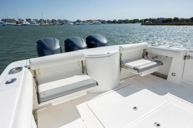  Yacht Photos Pics 2017 Everglades 355 Tournament boat with triple engines, spacious deck, and seating, on calm water.