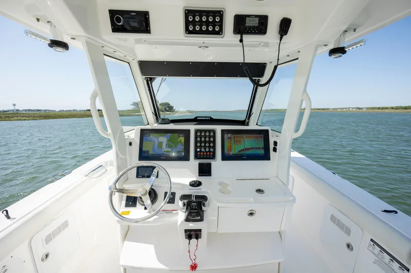  Yacht Photos Pics 2017 Everglades 355 Tournament boat cockpit with advanced navigation systems on open water.