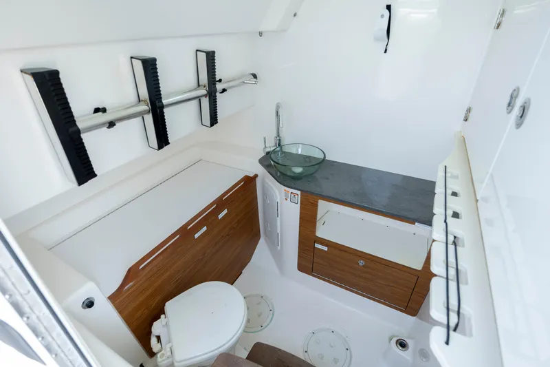  Yacht Photos Pics Interior of 2017 Everglades 355 Tournament boat, featuring a compact bathroom with modern amenities.