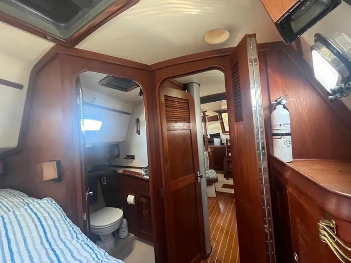  Yacht Photos Pics Interior of 1997 Island Packet 350 sailboat with wooden cabinetry and compact bathroom.