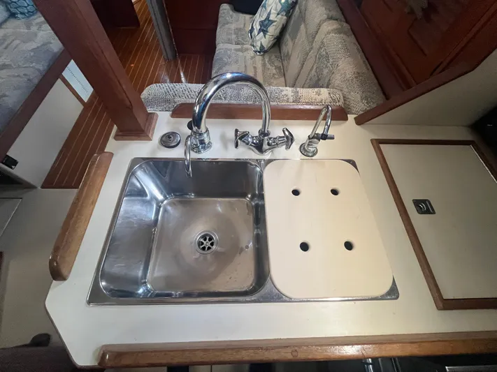  Yacht Photos Pics 1997 Island Packet 350 yacht kitchen sink with faucet and cutting board.