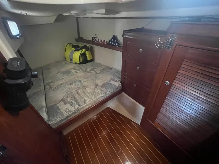  Yacht Photos Pics Cozy cabin interior of 1997 Island Packet 350 sailboat with wooden furnishings and storage.