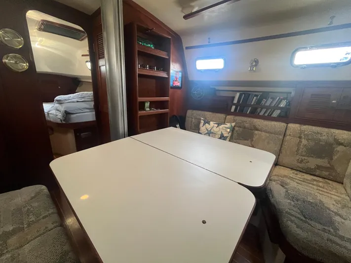  Yacht Photos Pics Interior of 1997 Island Packet 350 sailboat with cozy seating and dining area.