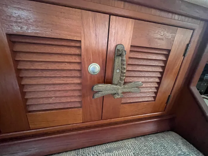  Yacht Photos Pics Wooden cabinet with louvered doors on a 1997 Island Packet 350 sailboat interior.