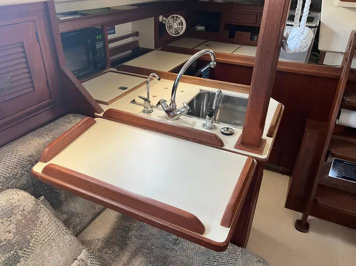  Yacht Photos Pics Interior of a 1997 Island Packet 350 sailboat with a compact kitchen area.