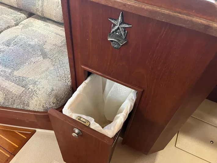  Yacht Photos Pics 1997 Island Packet 350 interior with built-in wooden trash compartment.