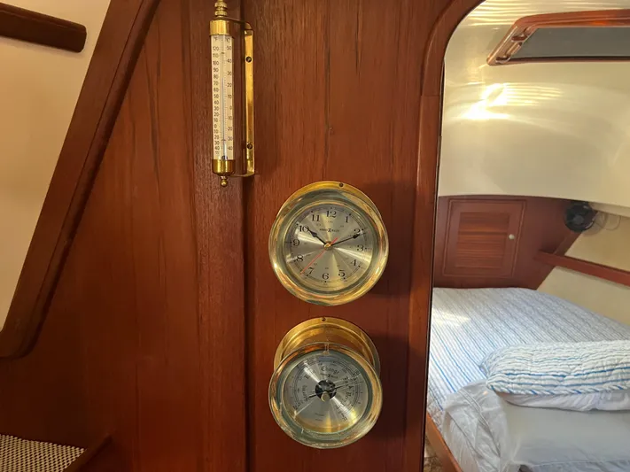  Yacht Photos Pics Interior of 1997 Island Packet 350 sailboat with brass clock and barometer.