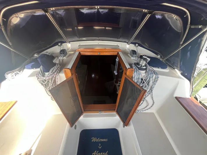  Yacht Photos Pics 1997 Island Packet 350 sailboat cockpit with open companionway and nautical decor.