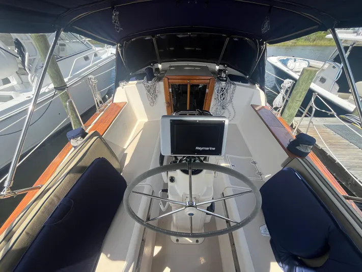  Yacht Photos Pics Cockpit of 1997 Island Packet 350 sailboat with steering wheel and navigation system.
