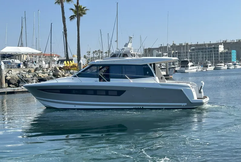 Tea Moana Yacht Photos Pics 2016 Jeanneau NC 11 yacht cruising in a marina with clear skies.