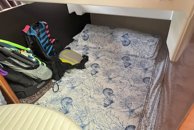 Tea Moana Yacht Photos Pics Cozy cabin interior of 2016 Jeanneau NC 11 with floral bedding and stored gear.