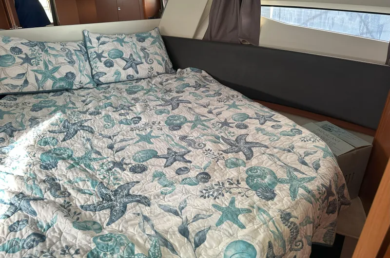 Tea Moana Yacht Photos Pics Cozy bedroom in 2016 Jeanneau NC 11 boat with nautical-themed bedding.