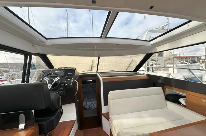 Tea Moana Yacht Photos Pics Interior of 2016 Jeanneau NC 11 boat with panoramic windows and modern seating.