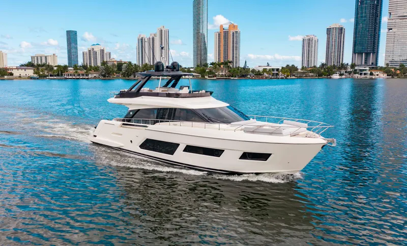 Our Trade Yacht Photos Pics 2022 Ferretti Yachts 670 cruising in a cityscape marina setting.