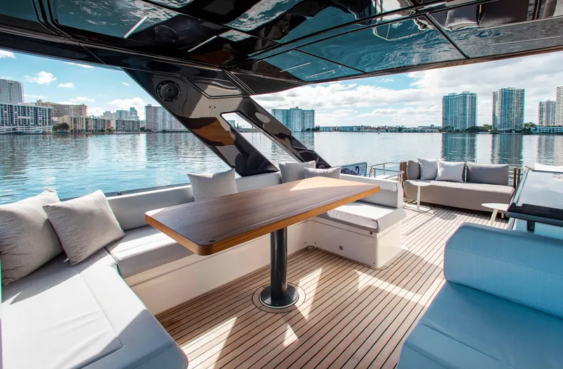 Our Trade Yacht Photos Pics Luxurious 2022 Ferretti Yachts 670 with elegant seating and scenic waterfront view.